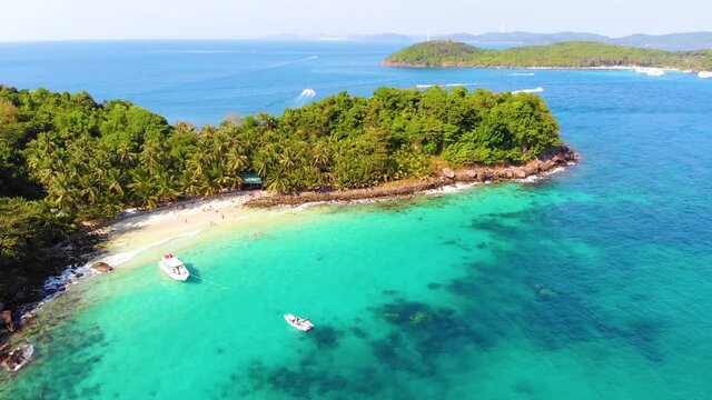 Aerial view of beautiful landscape, tourism boats, and people swimming on the sea and beach on May Rut island (a tranquil island with beautiful beach) in Phu Quoc, Kien Giang, Vietnam.