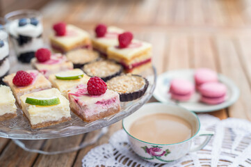 Cup of coffee and desserts on table, close-up.