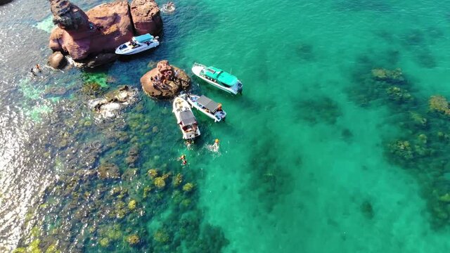 Aerial view of beautiful landscape, tourism boats, and people swimming on the sea and beach on May Rut island (a tranquil island with beautiful beach) in Phu Quoc, Kien Giang, Vietnam.