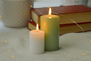 Fototapeta na wymiar burning candle on a wooden background