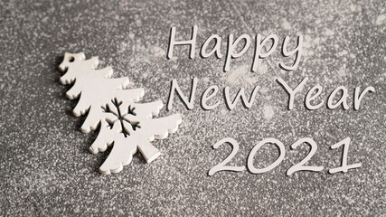 Happy New Year 2021 background. Wooden Christmas tree as a Christmas ornament on cement background
