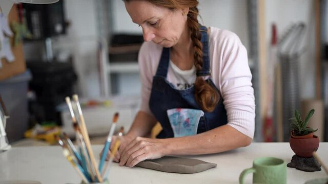 Woman at work in ceramic pottery creative studio - Handmade  handcraft artist 