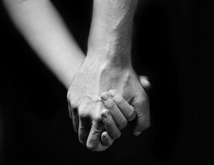 Strong male hand hold female hand