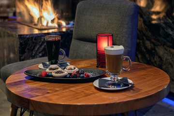 Mulled wine and latte on fireplace