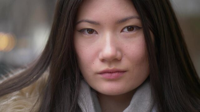 street closeup portrait of asian young pretty woman in winter