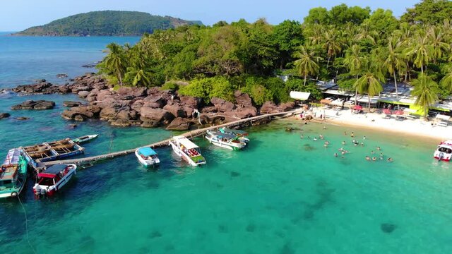 Aerial view of beautiful landscape, tourism boats, and people swimming on the sea and beach on May Rut island (a tranquil island with beautiful beach) in Phu Quoc, Kien Giang, Vietnam.