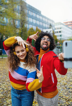 Young Couple With Smartphone Making Video Outdoors On Street, Tik Tok Concept.