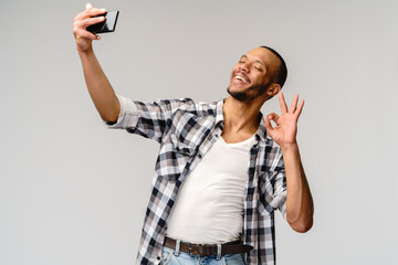 Happy african american man using mobile phone for video call