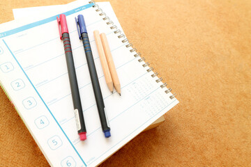 notebooks and pens on the table	