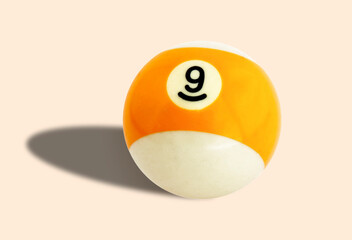 Billiard (pool) ball yellow color number 9 (nine) on a background colour #faebd7
