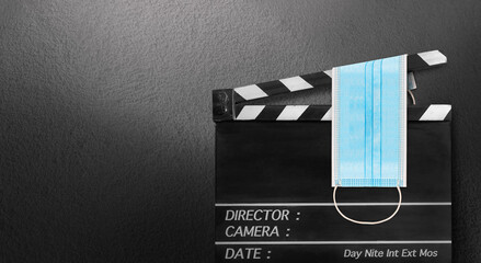 surgical mask on film slate.Storytelling concept of COVID-19,Coronavirus movie.