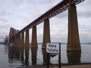 bridge over the river with restroom sign