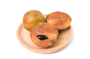 Sapodilla fruit on wooden plate isolated on a white background