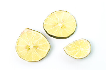 Top view of dried lime sliced on a white background.