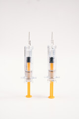 Two syringes on vertical white background for injection. Healthcare and Medical concept for covid-19. A covid-19 coronavirus vaccination concept. It use for prevention, immunization and treatment.