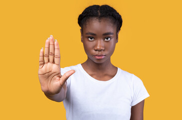 Determined African Woman Gesturing Stop Posing Standing Over Yellow Background