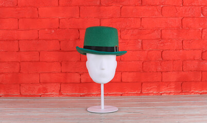 christmas elf hat on red brick wall background