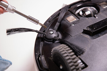 Clean brush cleaned and installed on the robot vacuum cleaner, close-up.