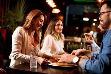 Young people having dinner in the restaurant