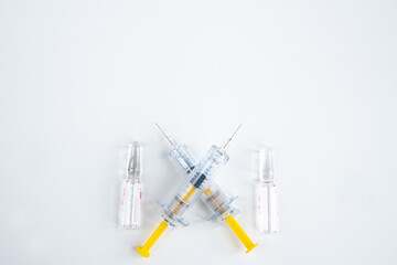 Two syringes and pharmaceutical vial on white background for injection. Healthcare and Medical concept for covid-19. A covid-19 coronavirus vaccination concept. Flat lay, top view, copy space