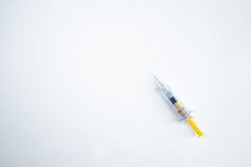 Syringe on white background for injection. Healthcare and Medical concept for covid-19. Covid-19 coronavirus vaccination concept. It use for immunization and treatment. Flat lay, top view, copy space.