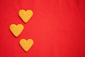 Happy valentine's day, heart cookies on red background