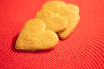 Heart shaped gingerbread cookie on red background
