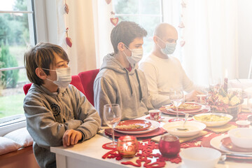 Family celebrating christmas and togetherness with face mask.