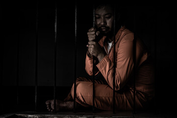 Asian man desperate at the iron prison,prisoner concept,thailand people,Hope to be free,Serious...