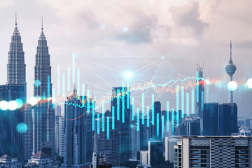 Forex and stock market chart hologram over panorama city view of Kuala Lumpur. KL is the financial center in Malaysia, Asia. The concept of international trading. Double exposure.