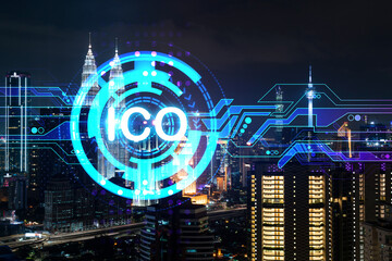 Initial coin offering hologram, night panorama city view of Kuala Lumpur. KL is the center of cryptocurrency projects in Malaysia, Asia. The concept of widespread ICO hysteria. Double exposure.