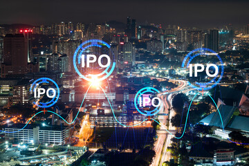 Initial public offering hologram, night panoramic city view Kuala Lumpur. KL is the financial center for multinational corporations in Malaysia, Asia. The concept of boosting growth by IPO process.