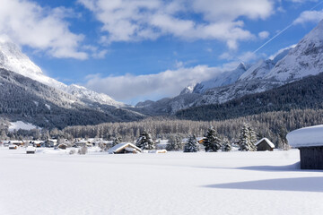 Ehrwald Valley, Tirol, Austria. Winter mountain landscape, Sunny day with white clouds on blue sky.