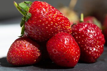 Large red strawberries on a Sunny day close-up. The concept of healthy vitamin food