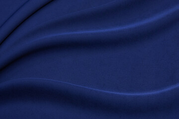 Crumpled blue fabric textured background. Abstract pattern and empty template. Selective focus with...
