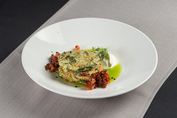 Zucchini pancakes served with sun-dried tomatoes and cream cheese