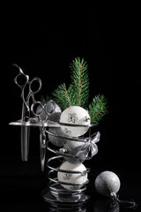 Banner with hairdressing tools in silver color. A Christmas tree with balloons is decorated with a set of professional tools.
