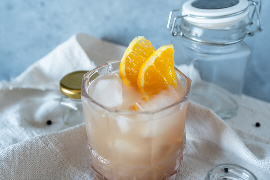 Iced cocktail with fresh orange garnish
