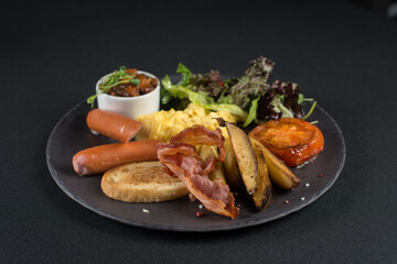 Traditional English breakfast. Sausage, beans, eggs, bread and salad