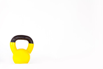 Yellow kettlebell on a black background