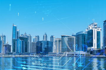 Fototapeta premium Skyscrapers of Dubai business downtown. International hub of trading and financial services. Technology theme icons hologram, Fintech concept. Double exposure. Dubai Canal waterfront.