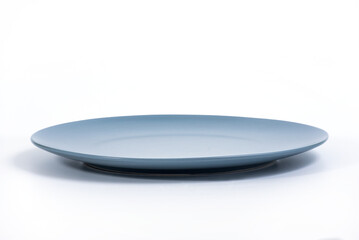 Large Empty Navy Blue plate isolated on white background side view, selective focus