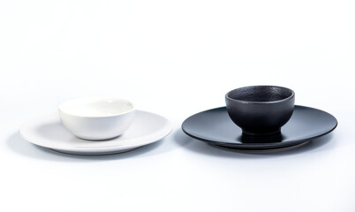 White and Black Bowls in White and Black Plates isolated on white background, side view.