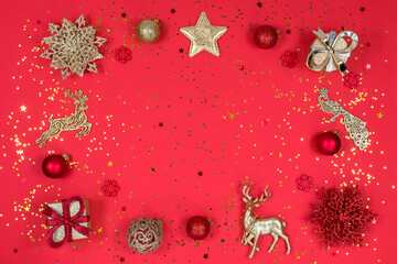 Gold and red Christmas decoration on a red background, top view, flat lay. New Year mood. Place for...