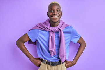 cheerful afro male in casual shirt posing at camera, smiling, having toothy smile, isolated over purple background