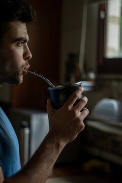 young male drinking mate