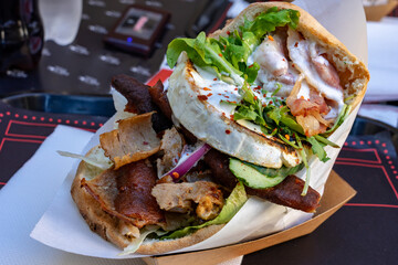 huge pita flat bread fast food filled with meat brie cheese and vegetables