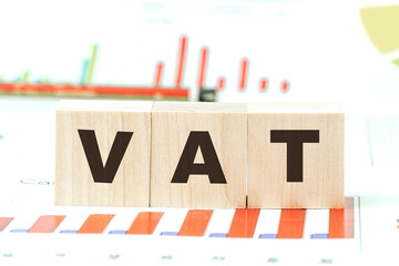 word vat with letters on wooden cubes on desk with graphs