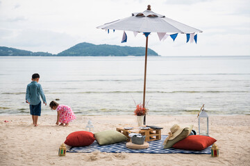 Family holiday vacation with beach picnic