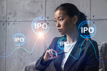 Asian businesswoman dream of success. IPO drawing hologram. Double exposure.